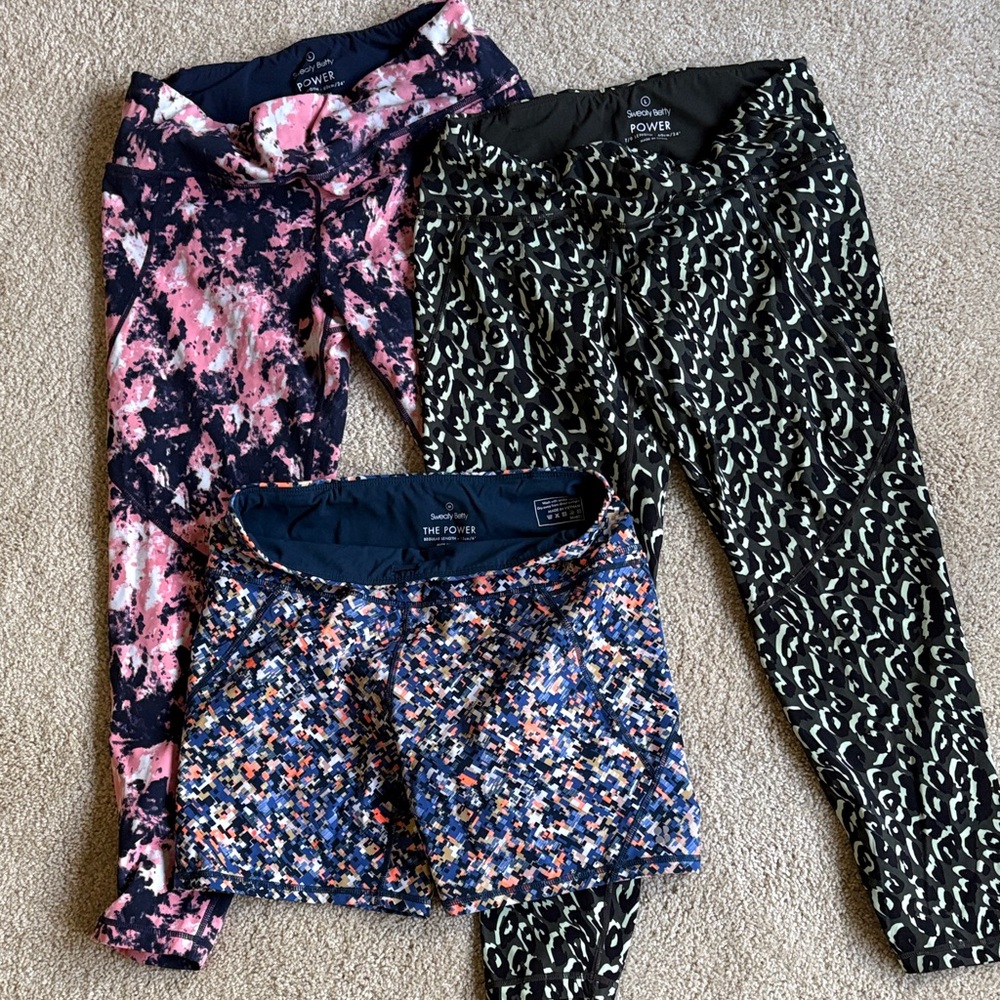 Sweaty Betty 3-pack.  Two 7/8 length Leggings and one 6” Short
